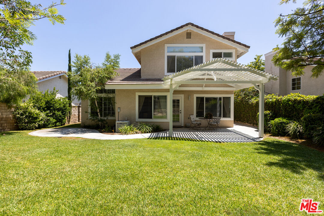 27050 Riversbridge Way Valencia, CA 91354 - Photo 20 of 37 a front view of a house with a yard