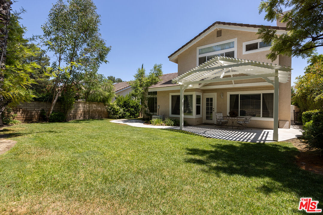 27050 Riversbridge Way Valencia, CA 91354 - Photo 24 of 37 a front view of a house with a yard