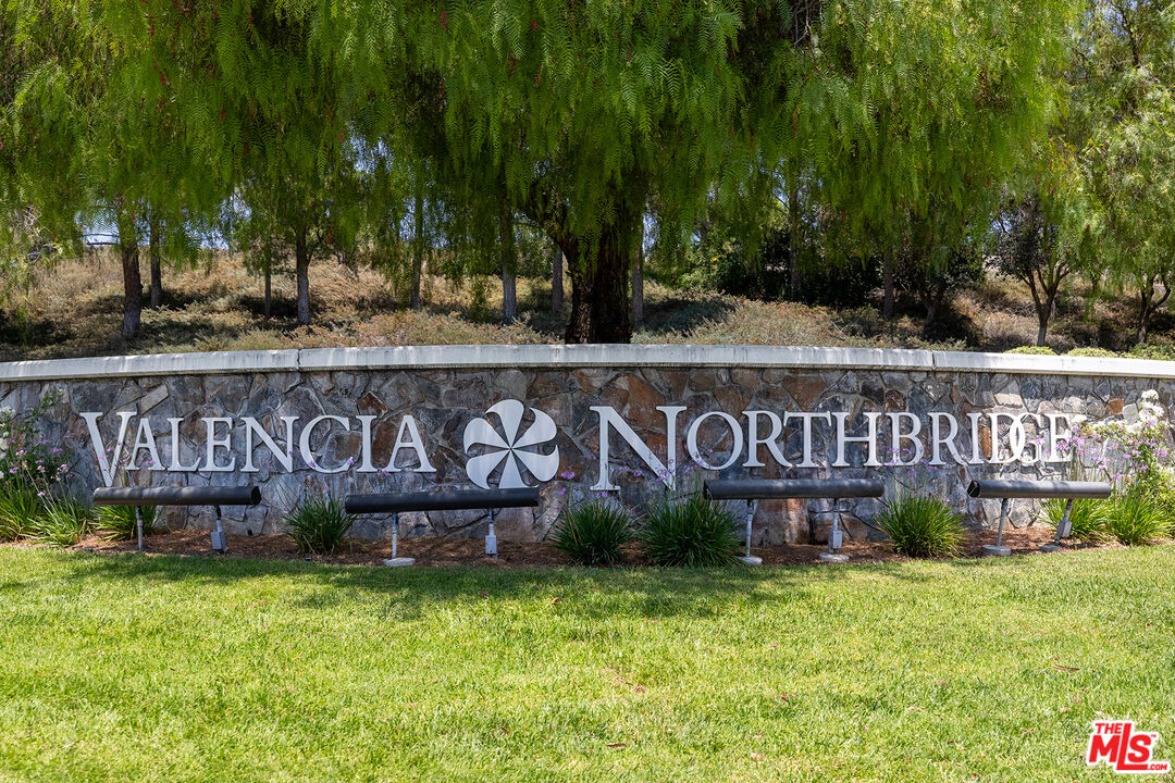 27050 Riversbridge Way Valencia, CA 91354 - Photo 28 of 37 a street sign that is sitting in front of a building