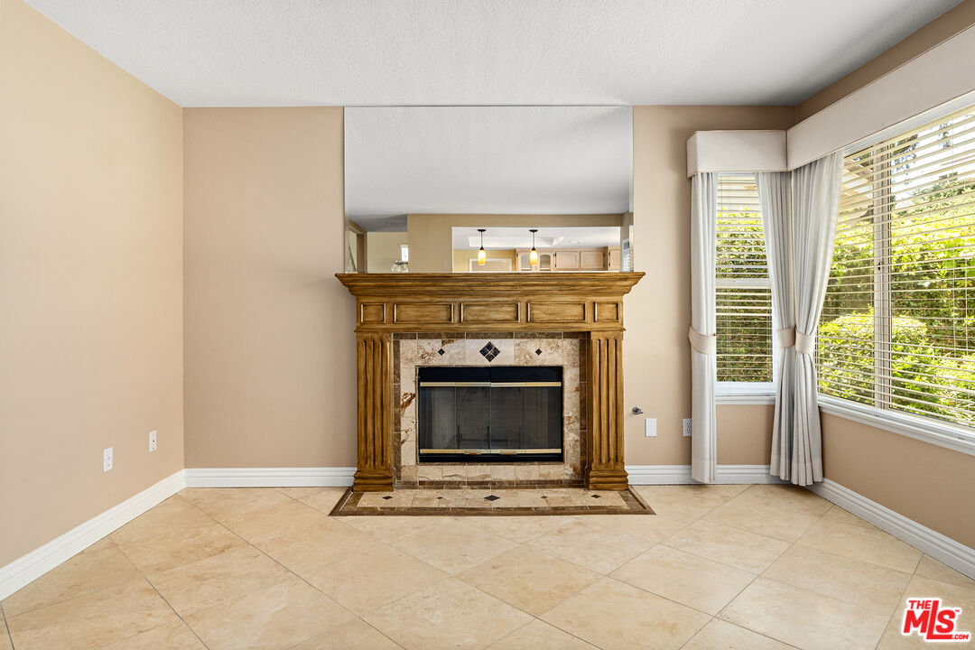 27050 Riversbridge Way Valencia, CA 91354 - Photo 8 of 37 a living room with a fireplace and a floor to ceiling window
