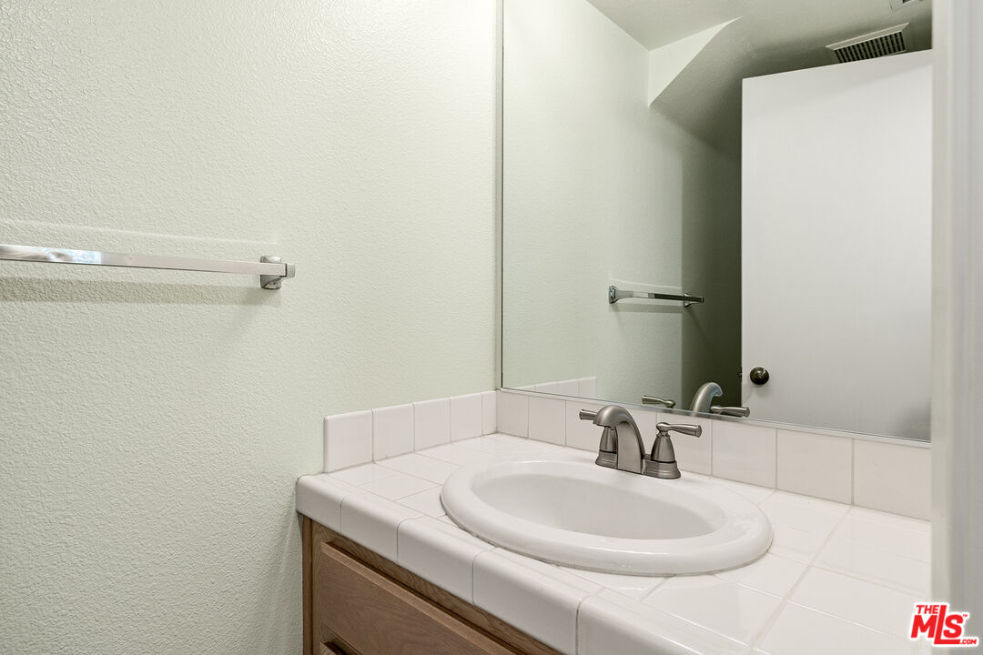 27050 Riversbridge Way Valencia, CA 91354 - Photo 9 of 37 a bathroom with a sink and a mirror