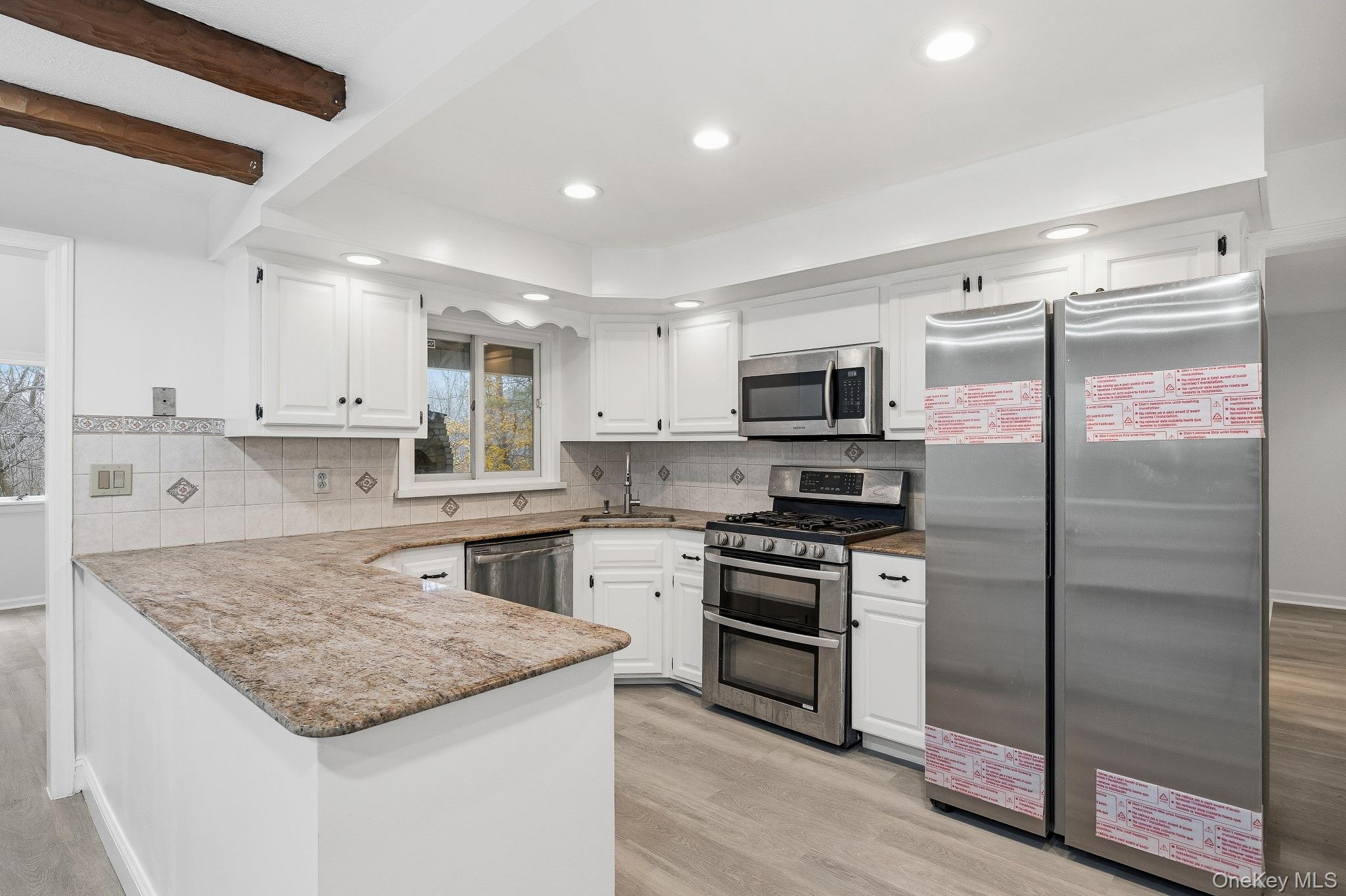 291 Boulevard Scarsdale, NY 10583 - Photo 11 of 31 a kitchen with kitchen island granite countertop a sink stove and refrigerator