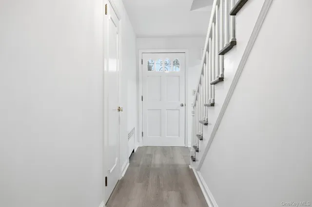 an empty room with windows and fireplace