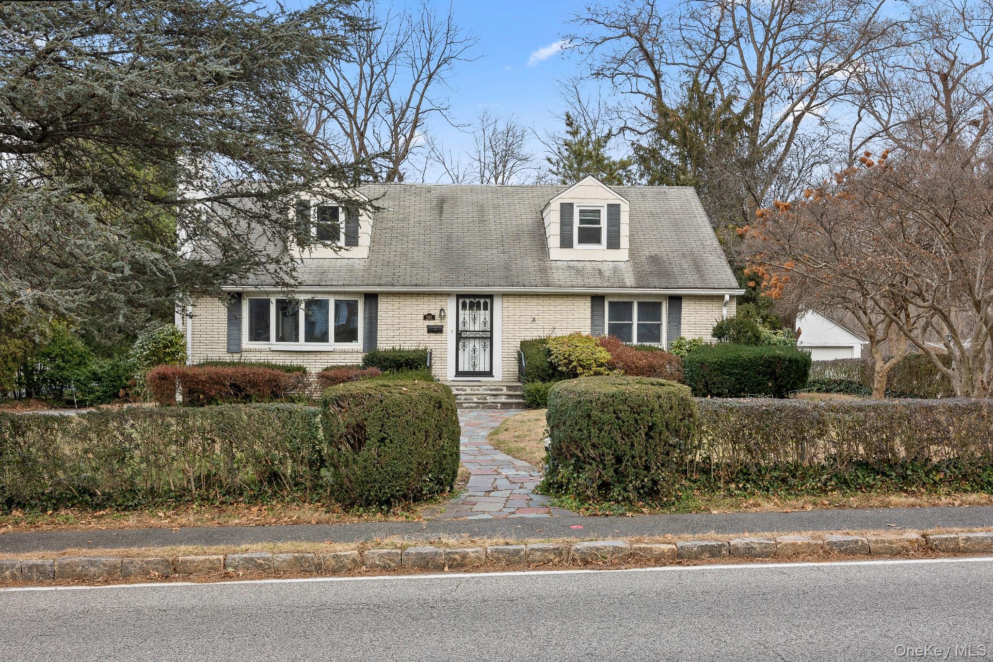 291 Boulevard Scarsdale, NY 10583 - Photo 2 of 31 a front view of a house with a yard and garage