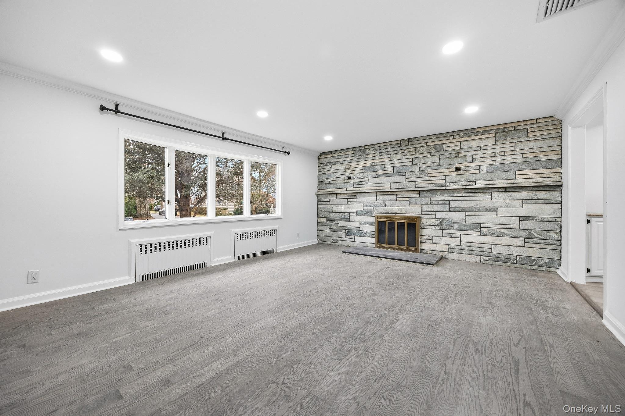 291 Boulevard Scarsdale, NY 10583 - Photo 7 of 31 a view of an empty room with a fireplace and a window