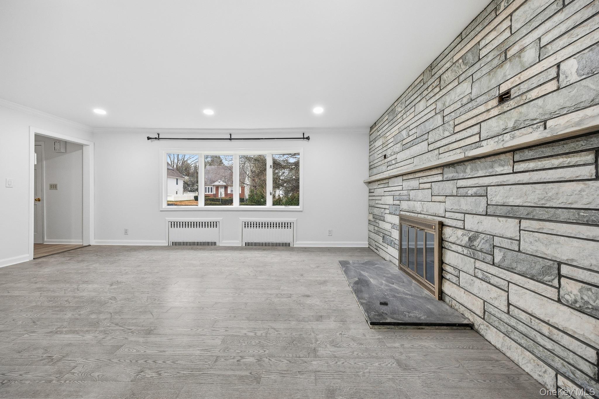 291 Boulevard Scarsdale, NY 10583 - Photo 8 of 31 a view of an empty room with a fireplace and a window