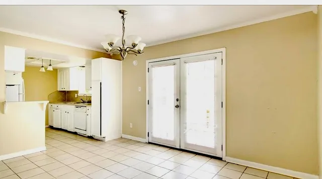 a view of a kitchen with cabinet and a chandelier fan