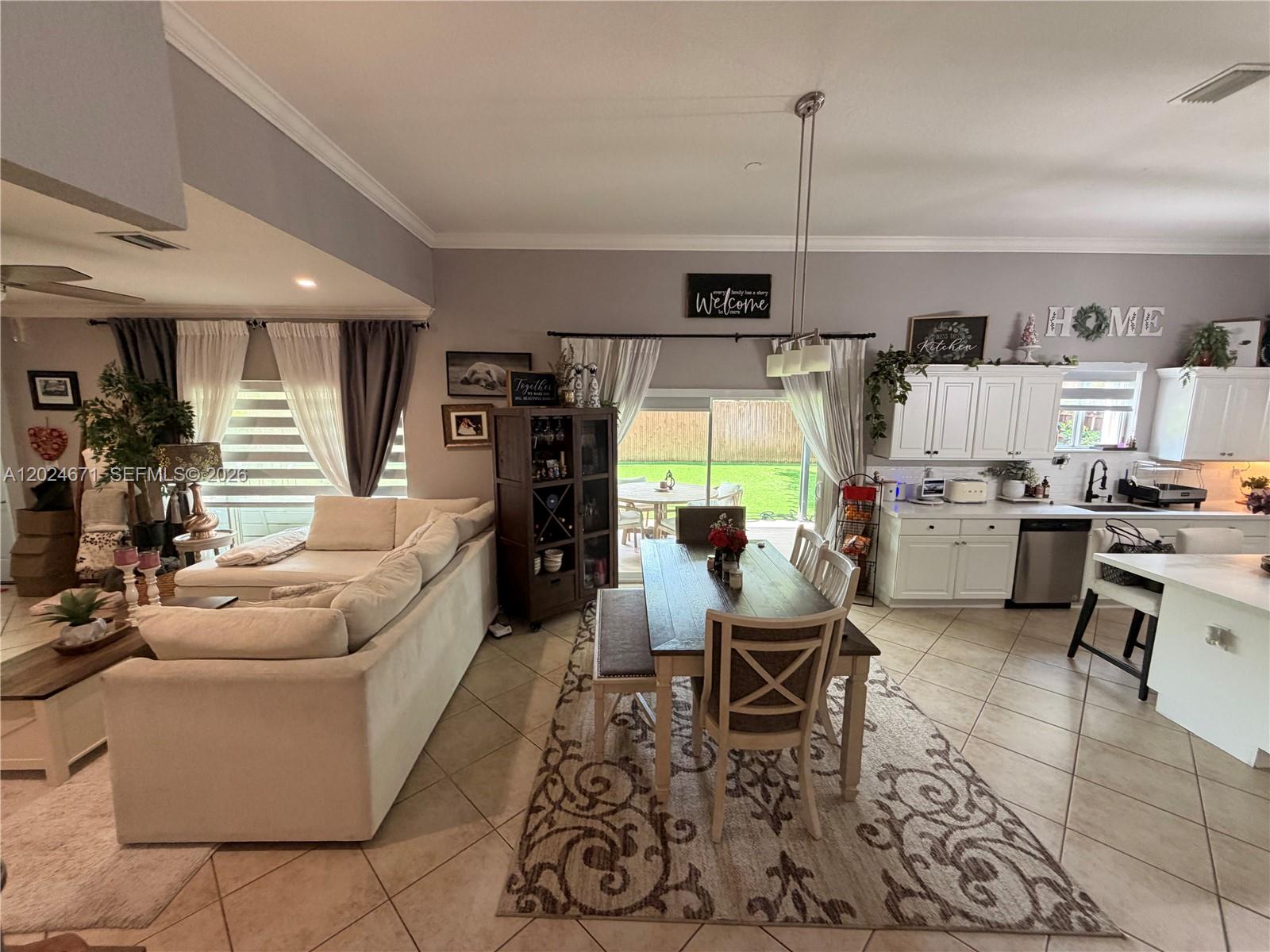 2116 Northeast 38th Road, Unit 2116 Homestead, FL 33033 - Photo 8 of 31 a living room with furniture and kitchen view