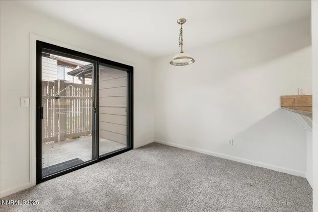 a view of empty room with floor to ceiling window