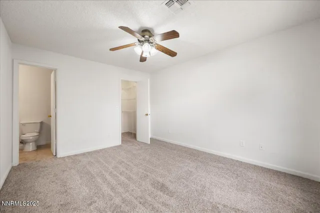 a view of an empty room and closet area