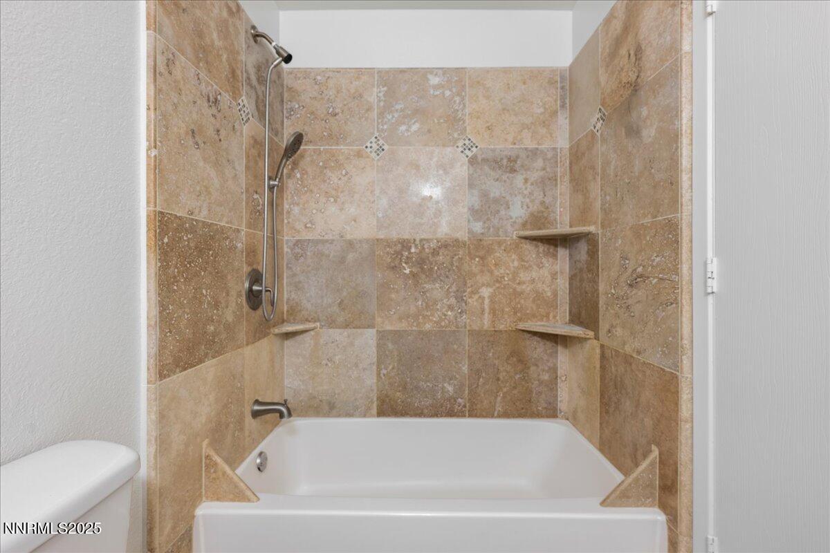 4418 Matich Drive Reno, NV 89502 - Photo 18 of 37 a bathroom with a bathtub and a toilet