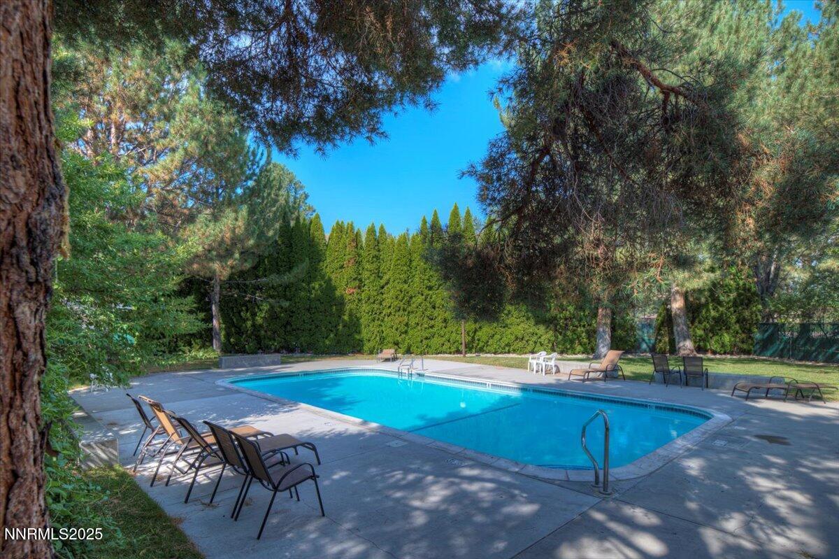 4418 Matich Drive Reno, NV 89502 - Photo 27 of 37 a view of a backyard with lawn chairs under an umbrella