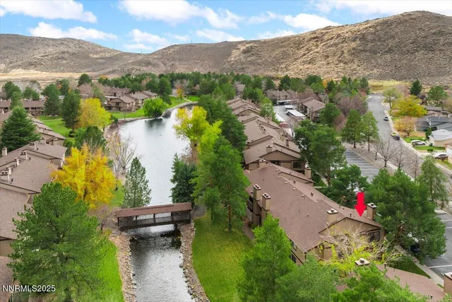 an aerial view of lake residential house with swimming pool and green space