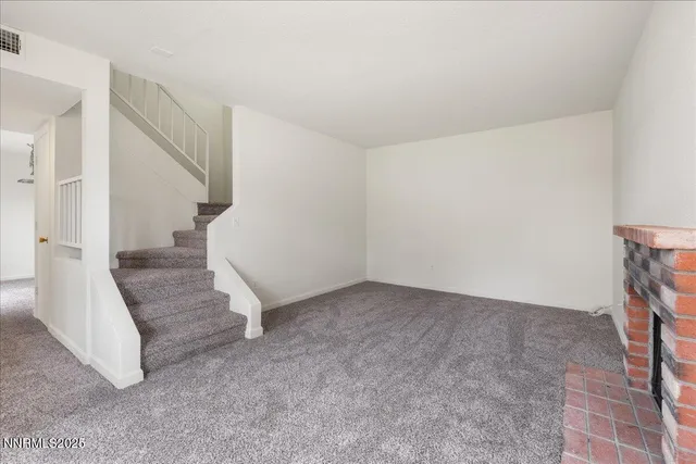 a view of an empty room with stairs