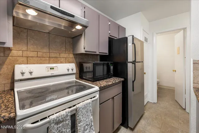 a kitchen with a refrigerator and a stove