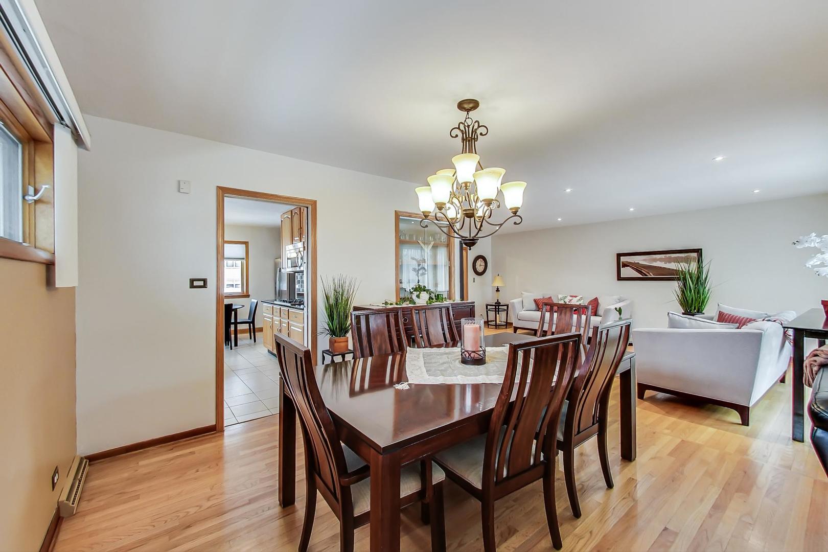 715 Lamon Avenue Wilmette, IL 60091 - Photo 11 of 54 a view of a dining room with furniture and wooden floor