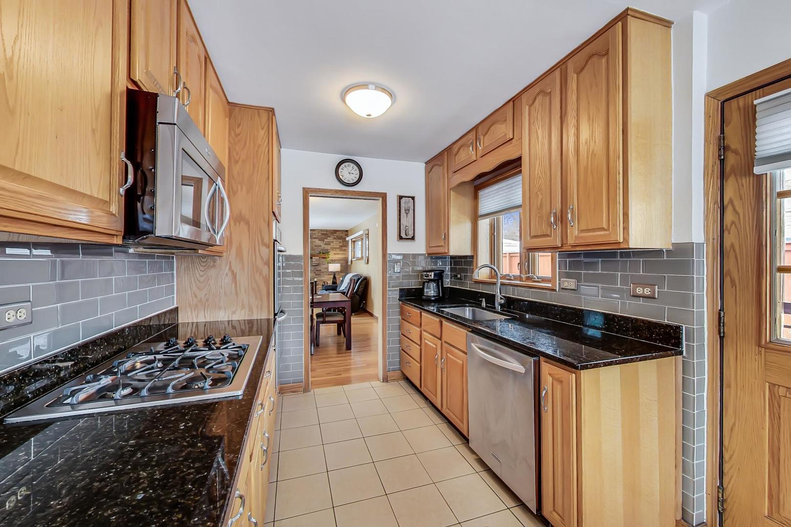 715 Lamon Avenue Wilmette, IL 60091 - Photo 12 of 54 a kitchen with stainless steel appliances a stove a sink and a refrigerator