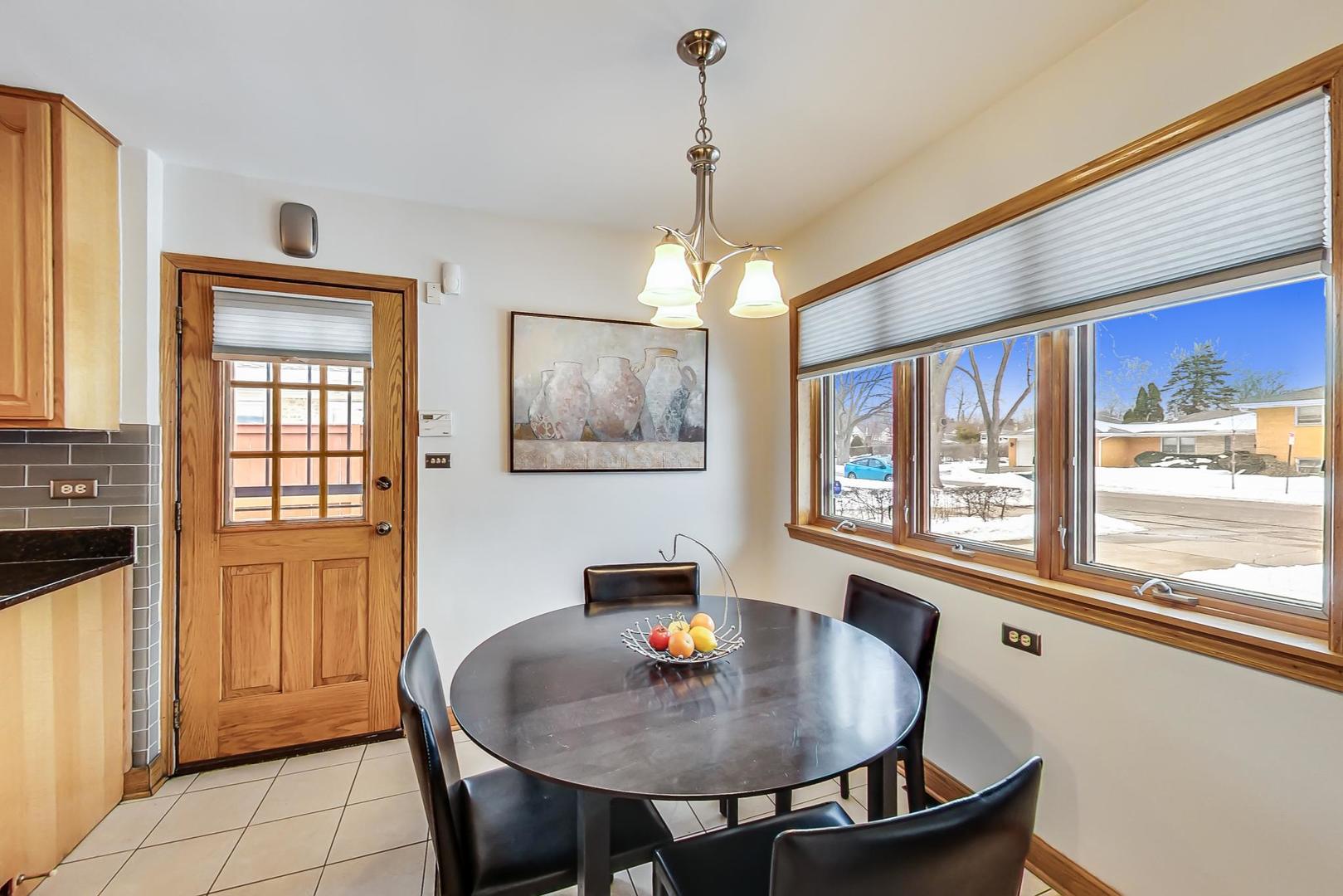 715 Lamon Avenue Wilmette, IL 60091 - Photo 16 of 54 a dining room with furniture a chandelier and window