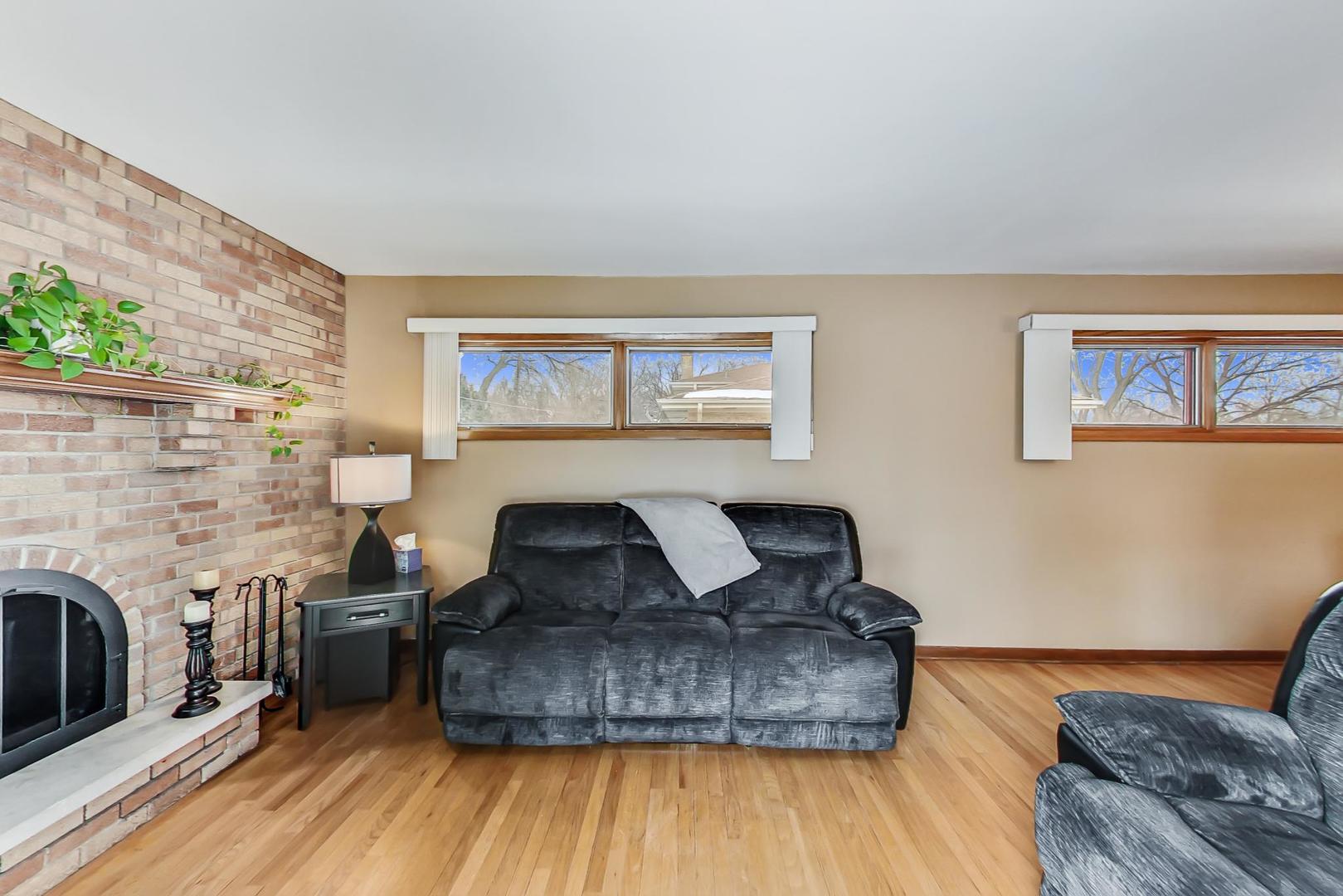 715 Lamon Avenue Wilmette, IL 60091 - Photo 18 of 54 a living room with furniture and a fireplace