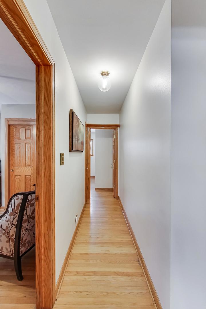 715 Lamon Avenue Wilmette, IL 60091 - Photo 20 of 54 a view of a hallway with wooden floor and staircase
