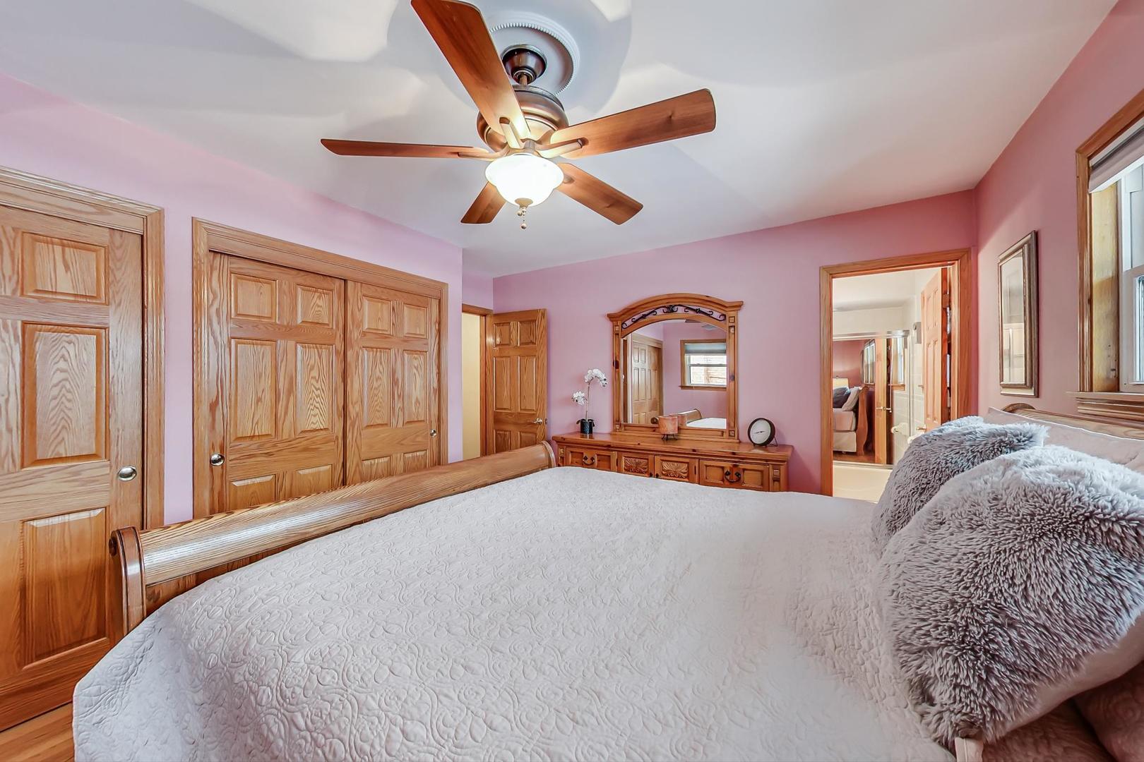 715 Lamon Avenue Wilmette, IL 60091 - Photo 22 of 54 a bedroom with a large bed and a large window