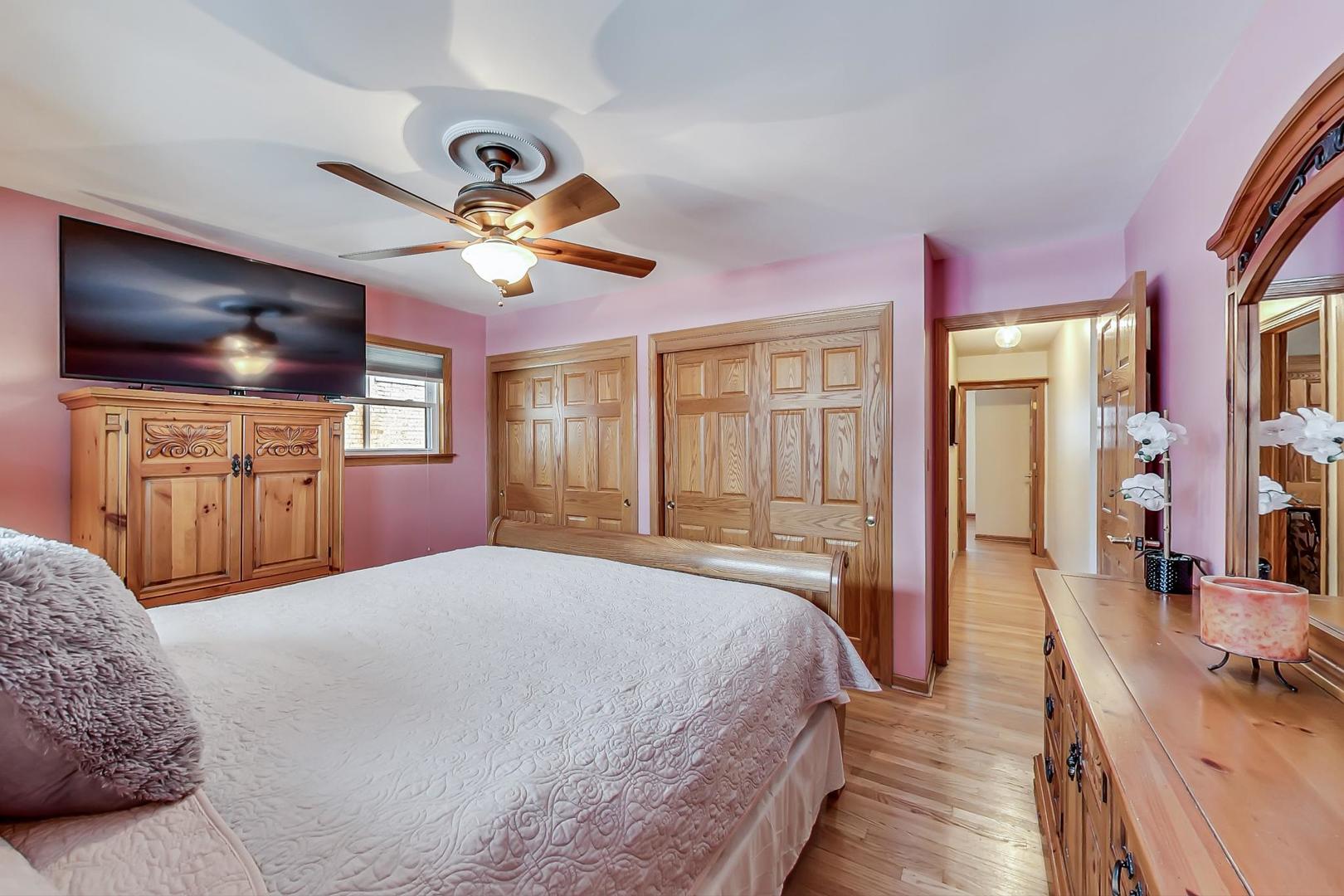 715 Lamon Avenue Wilmette, IL 60091 - Photo 23 of 54 a bedroom with a bed and a chandelier
