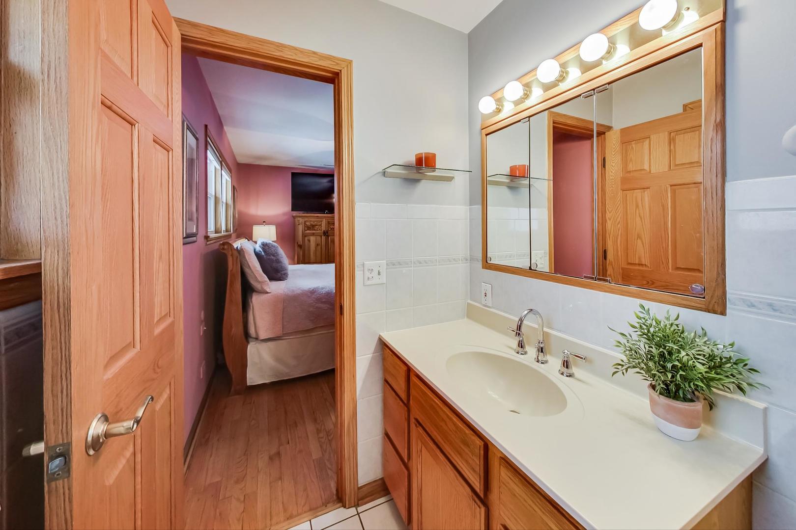 715 Lamon Avenue Wilmette, IL 60091 - Photo 25 of 54 a en suite bathroom with a sink double vanity and mirror