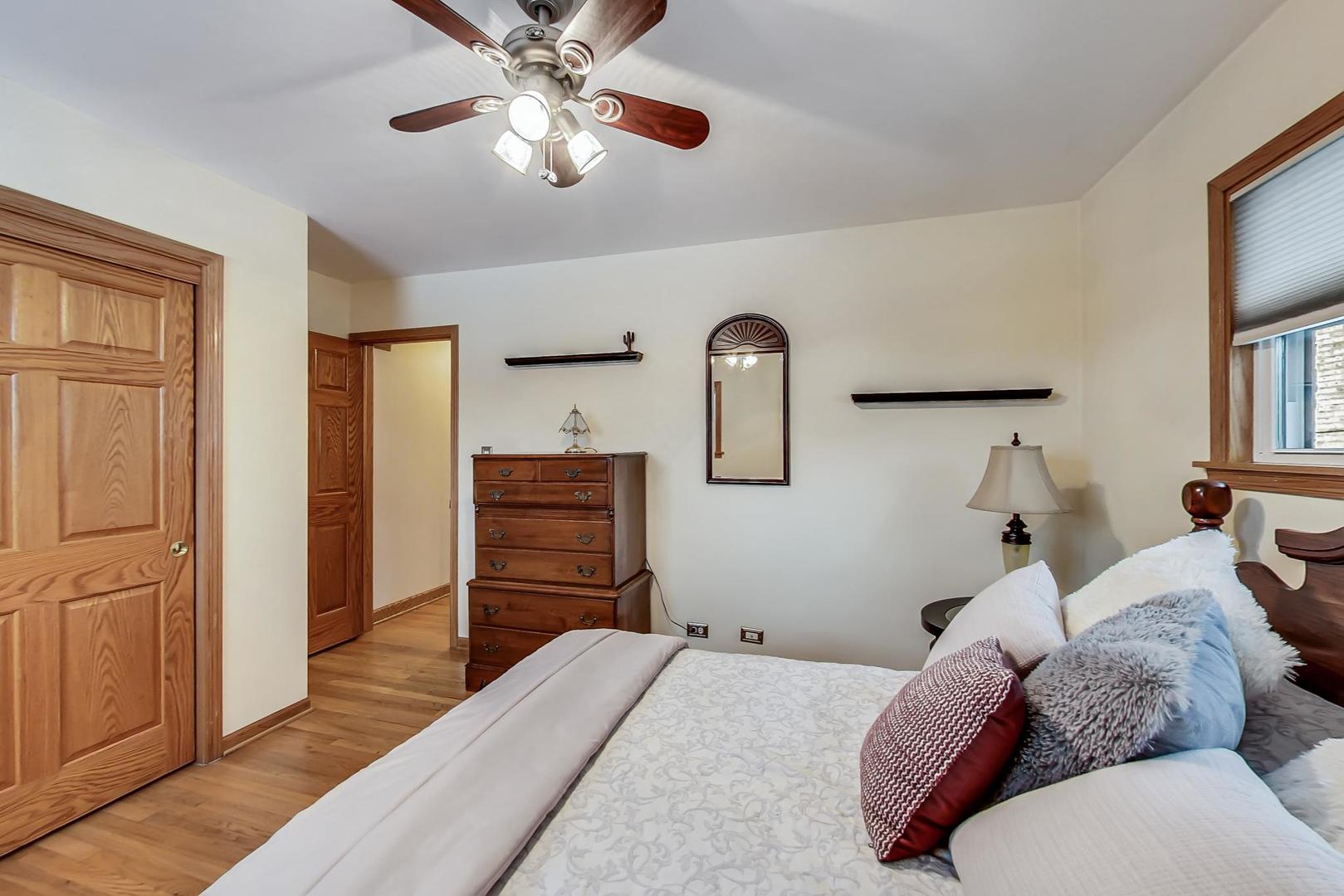 715 Lamon Avenue Wilmette, IL 60091 - Photo 28 of 54 a bedroom with bed and wooden cabinets