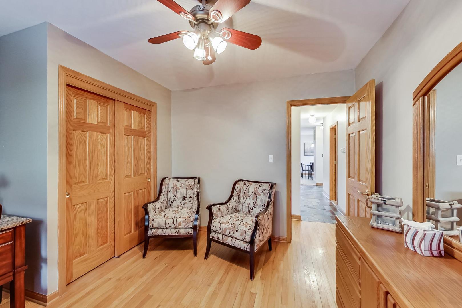 715 Lamon Avenue Wilmette, IL 60091 - Photo 30 of 54 a bedroom with furniture and a chandelier