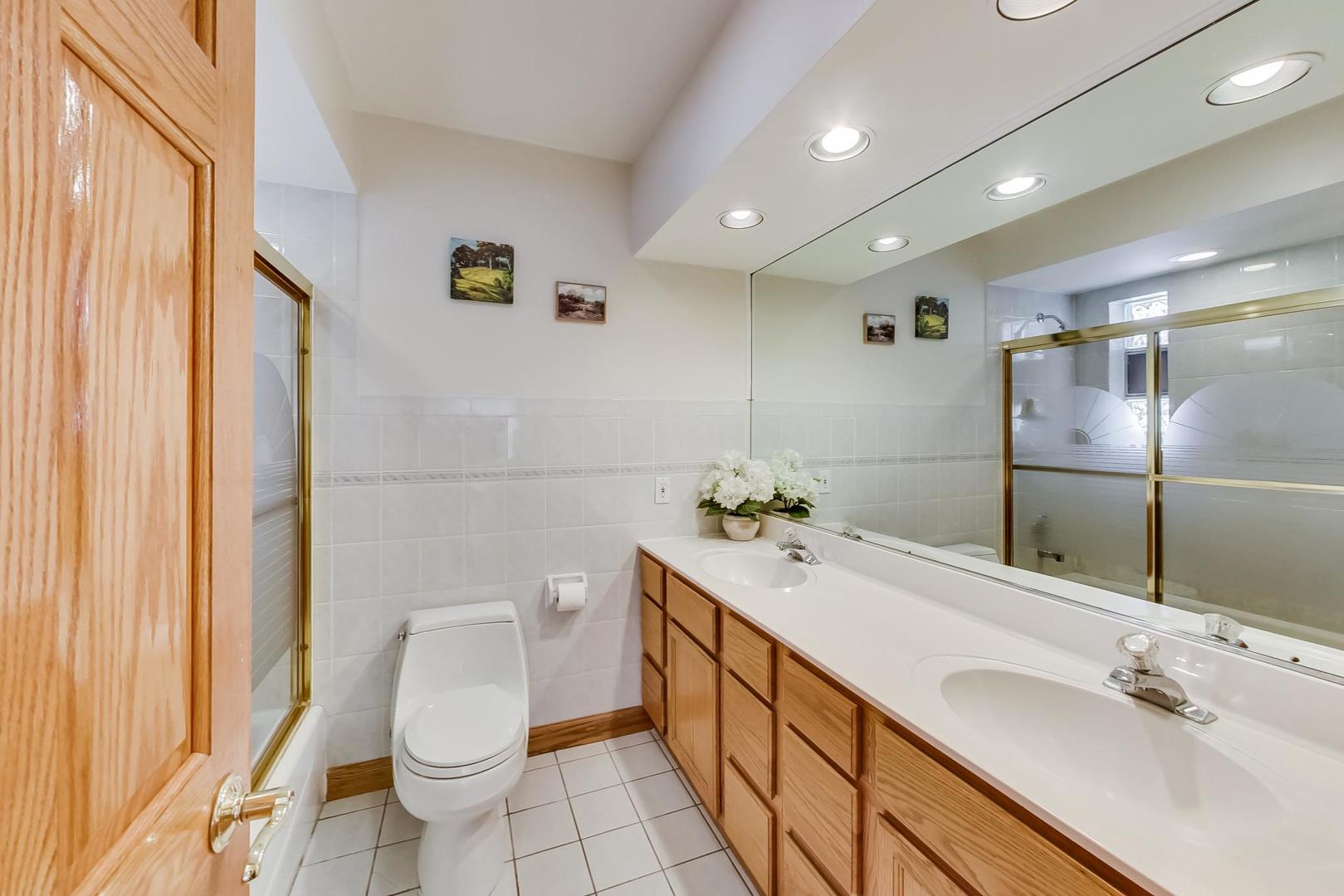 715 Lamon Avenue Wilmette, IL 60091 - Photo 32 of 54 a bathroom with a sink a toilet and shower