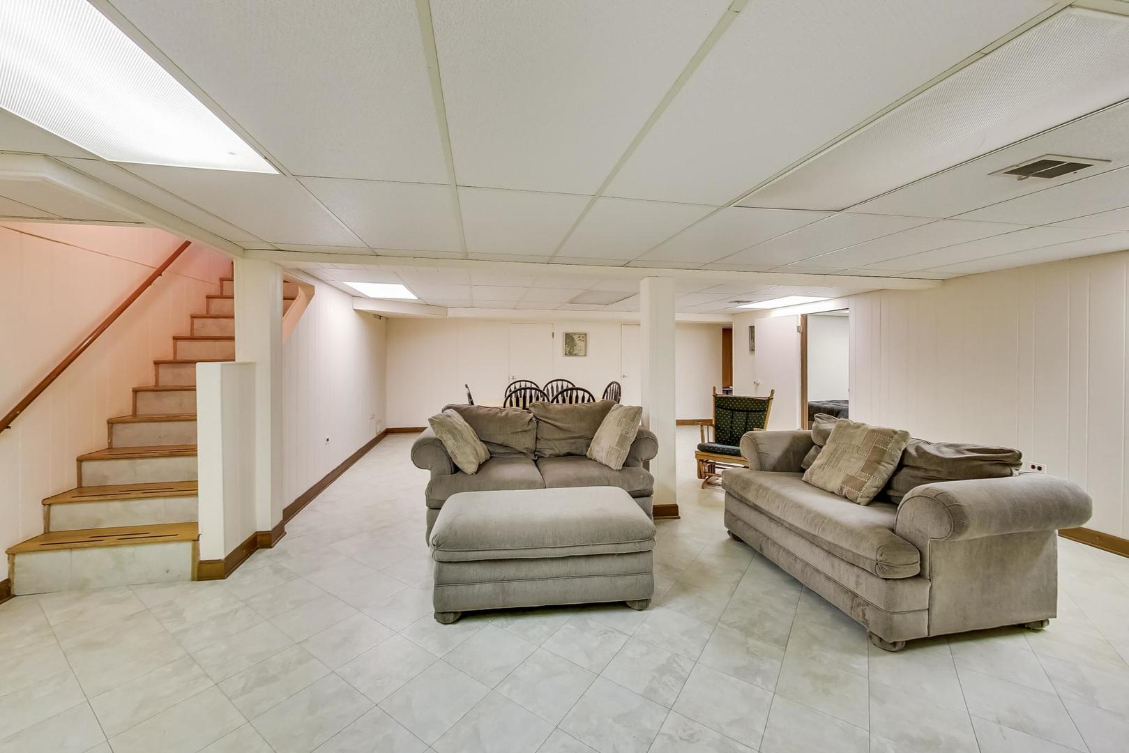 715 Lamon Avenue Wilmette, IL 60091 - Photo 34 of 54 a living room with furniture and stairs