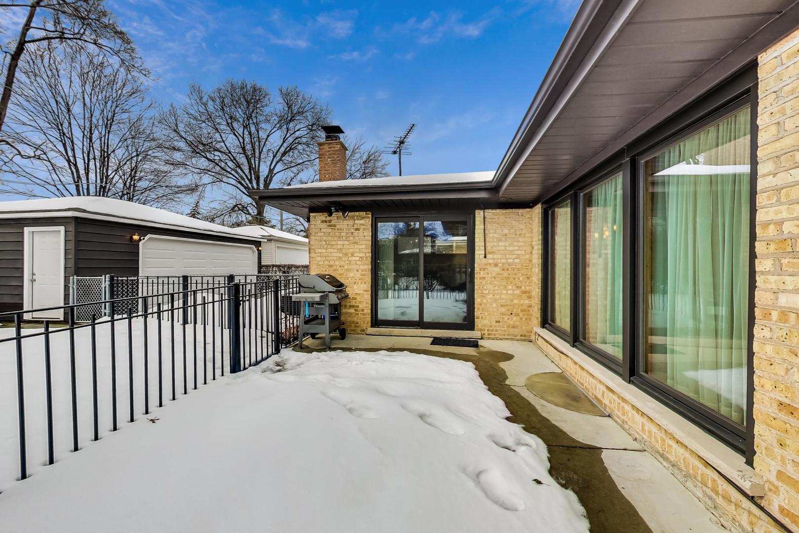 715 Lamon Avenue Wilmette, IL 60091 - Photo 47 of 54 a view of a house with a large window and wooden fence
