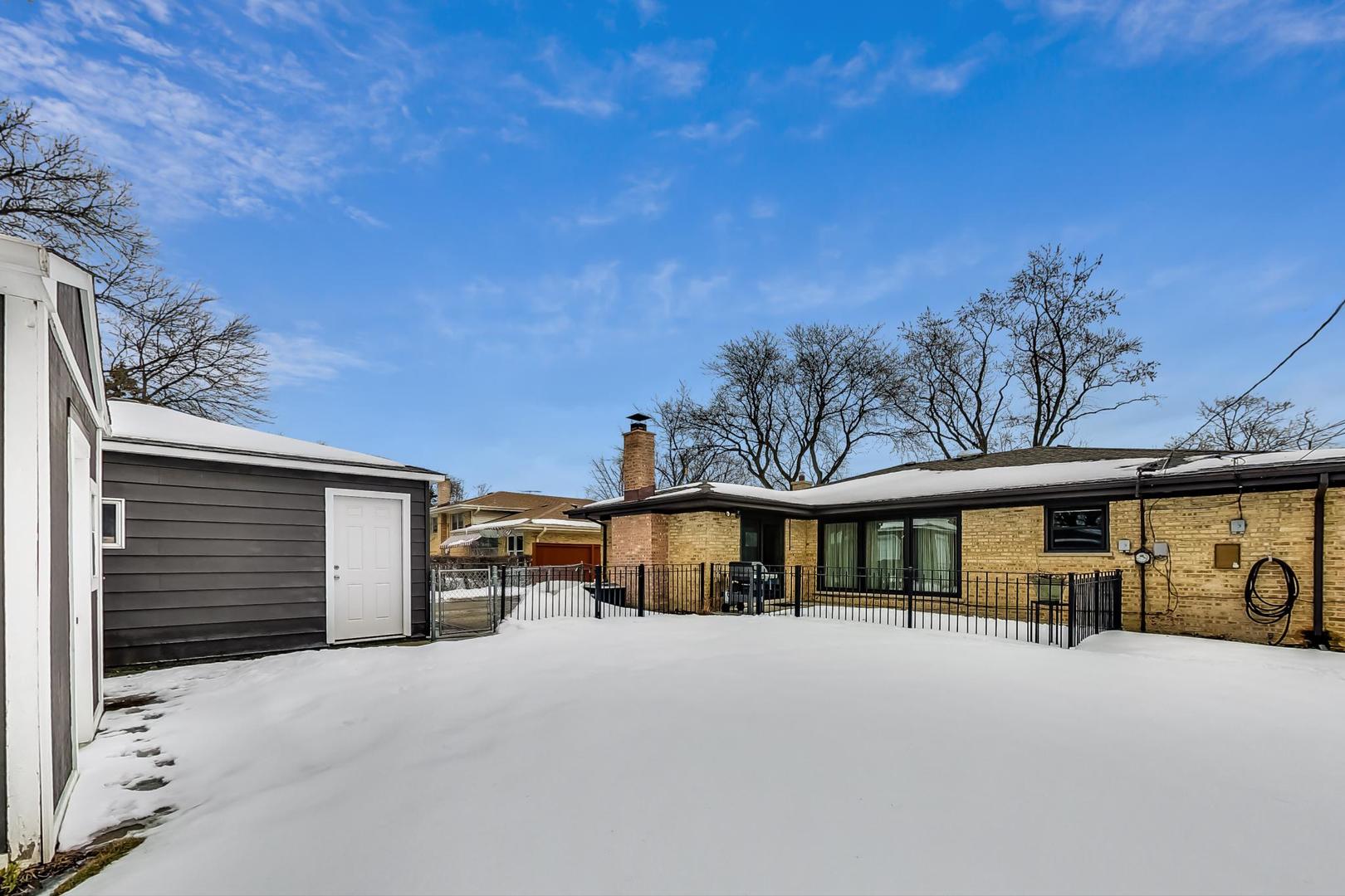 715 Lamon Avenue Wilmette, IL 60091 - Photo 50 of 54 a view of a house with a parking space and a car parked