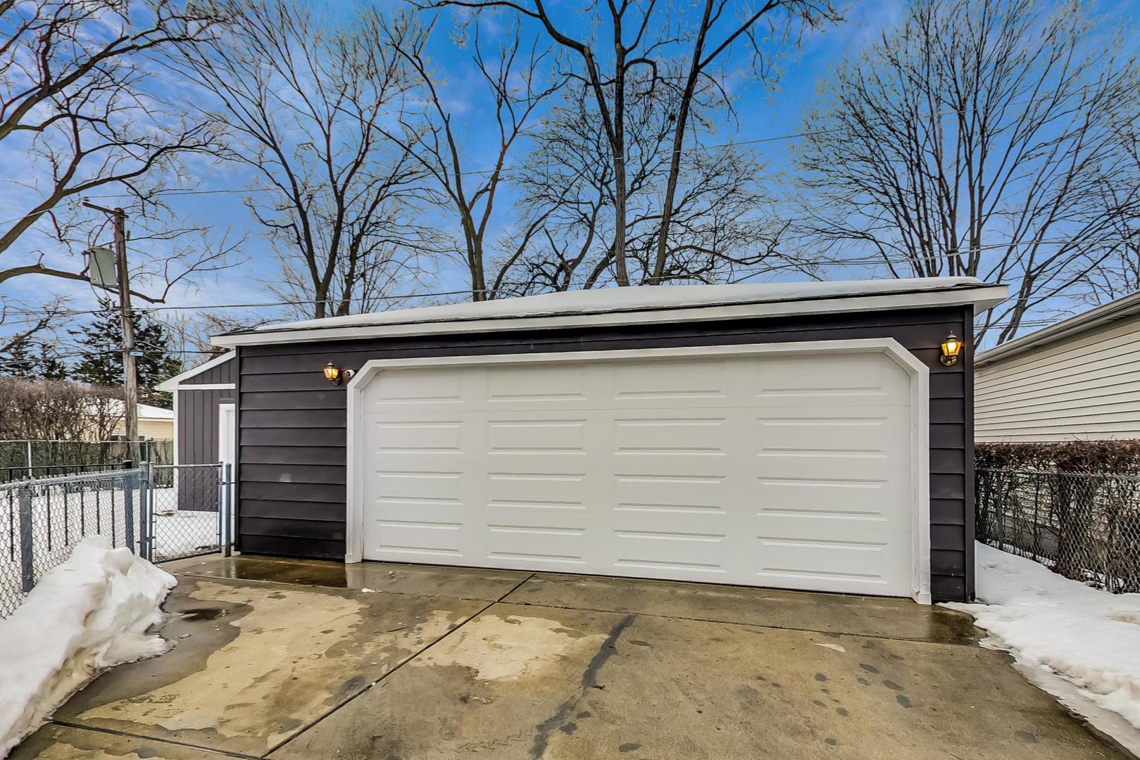 715 Lamon Avenue Wilmette, IL 60091 - Photo 52 of 54 a side view of a house with a yard and garage