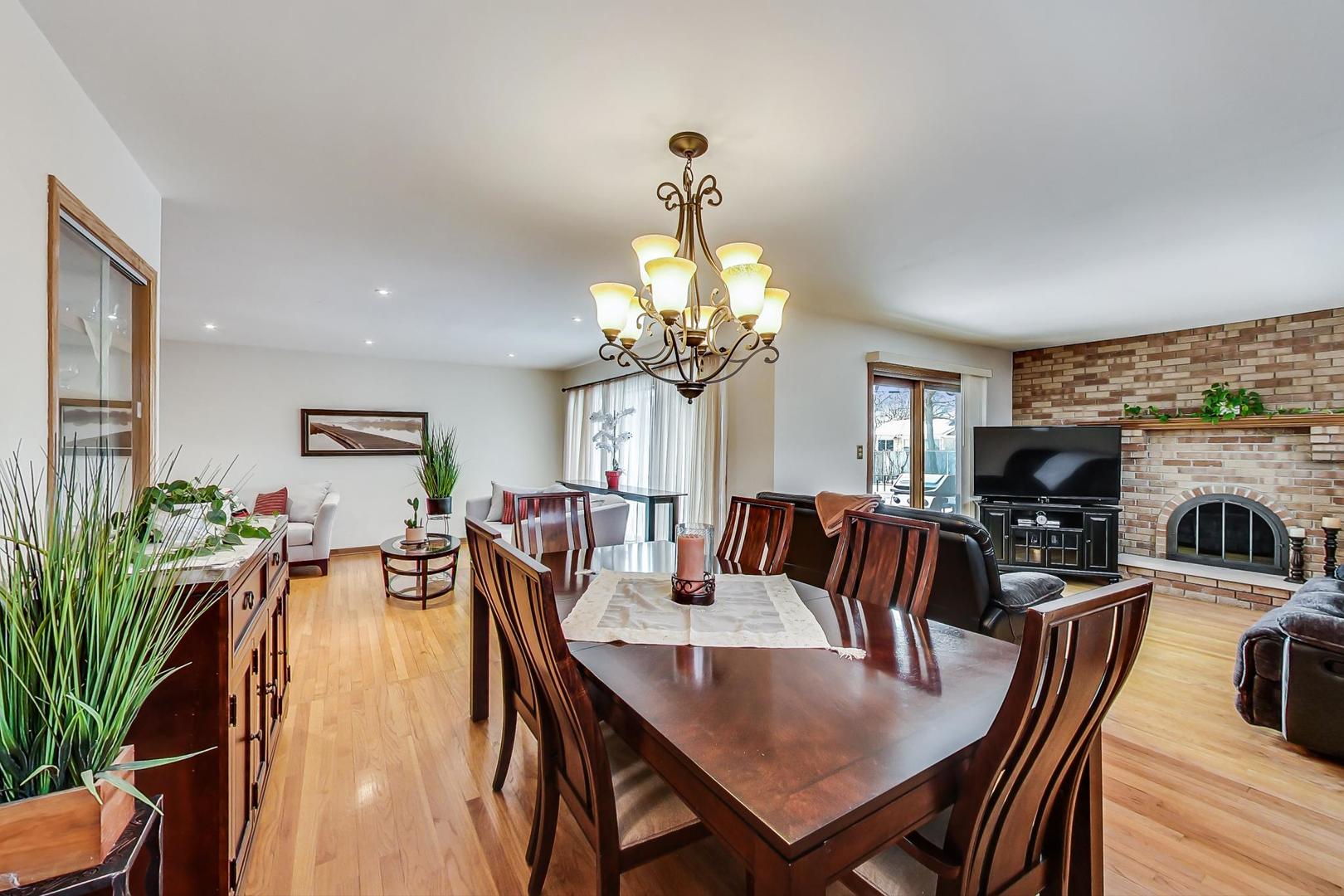715 Lamon Avenue Wilmette, IL 60091 - Photo 10 of 54 a view of a dining room and livingroom with furniture wooden floor a chandelier