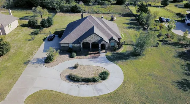 an aerial view of a house with outdoor space