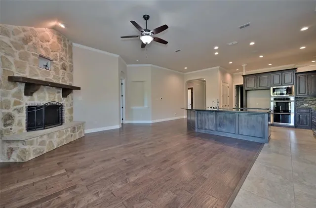a view of a kitchen with a sink and a fireplace