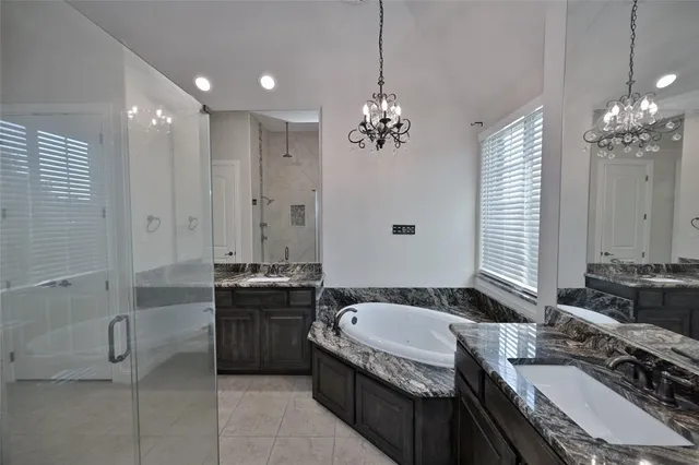 a spacious bathroom with a granite countertop tub sink and mirror