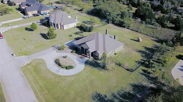 an aerial view of a house with a yard