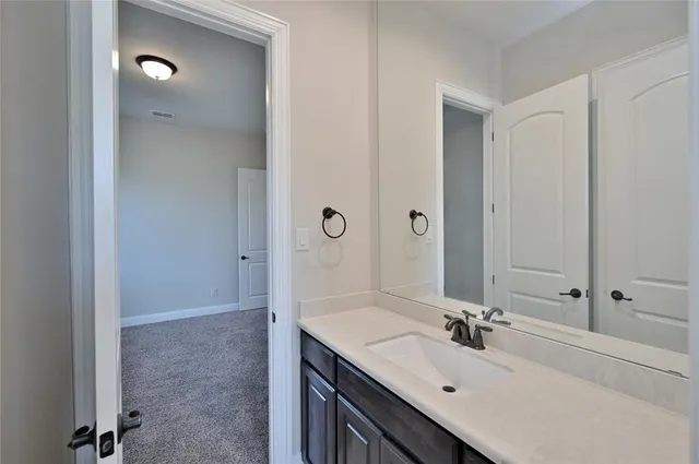 a bathroom with a sink vanity and mirror