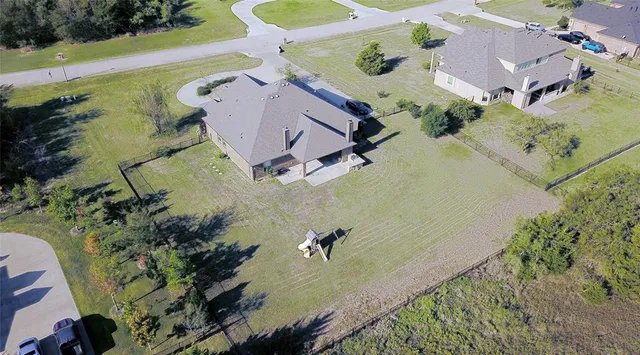 an aerial view of a house with a yard