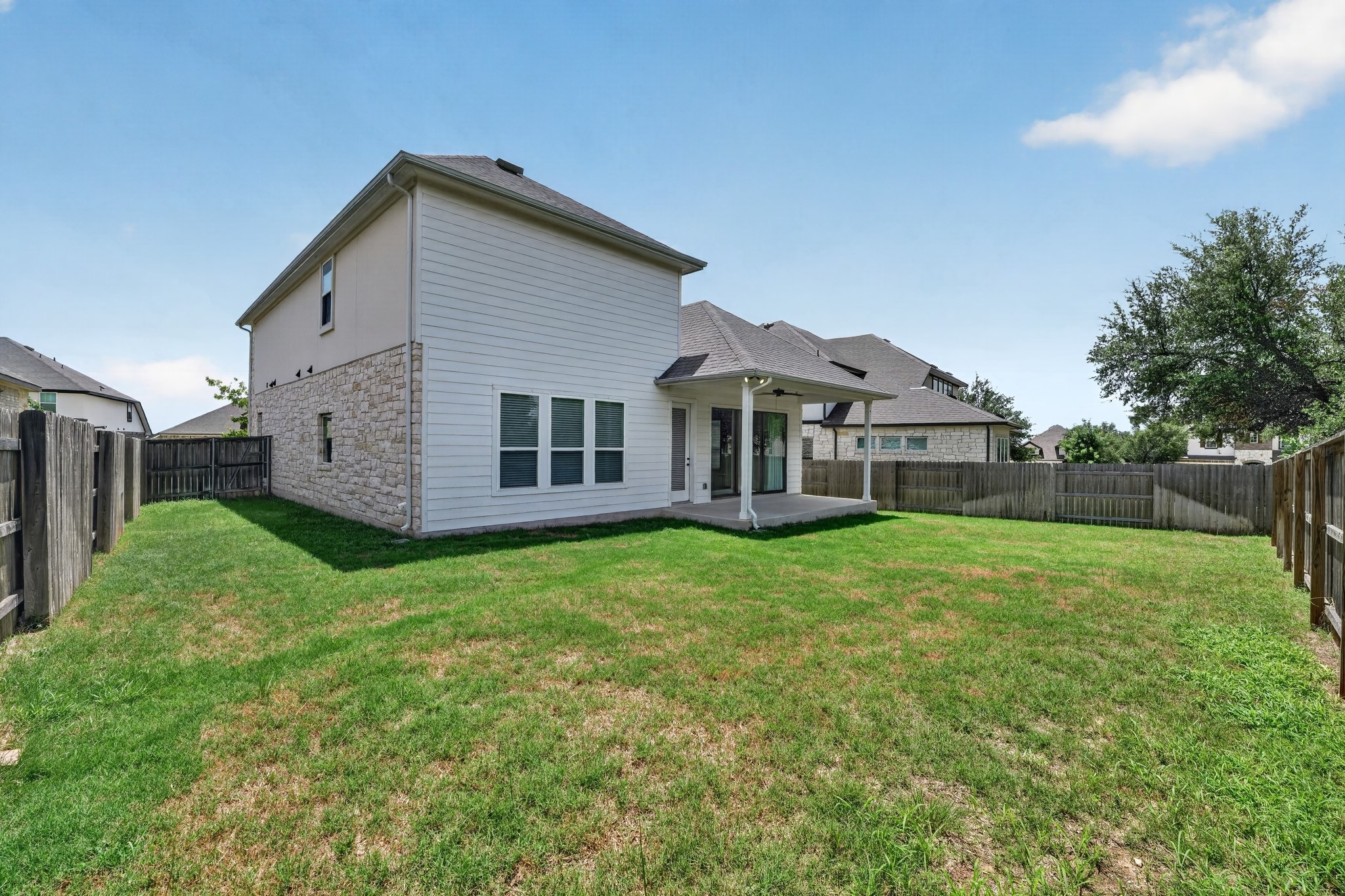 508 Pinnacle View Drive Georgetown, TX 78628 - Photo 26 of 27 A spacious backyard with mature trees, a covered patio, and a privacy fence creates an idyllic outdoor retreat.
