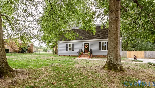 a front view of a house with a yard and a garden