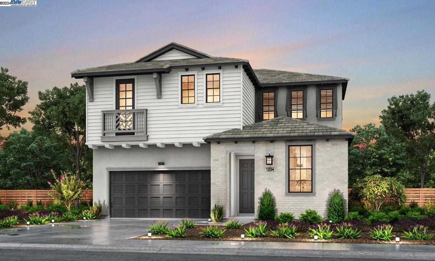 a front view of a house with a garden and garage