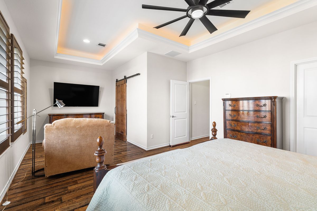 1116 Highknoll Lane Georgetown, TX 78628 - Photo 21 of 36 a bedroom with a bed and a flat screen tv