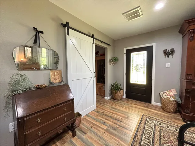 a bedroom with furniture and wooden floor
