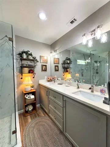 a en suite bathroom with a sink and mirror