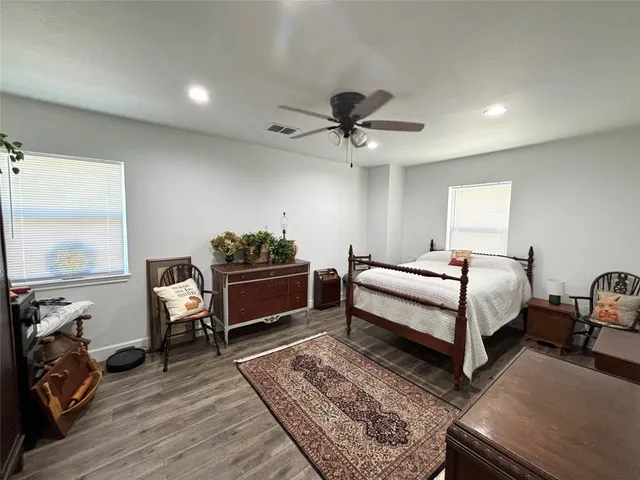 a bedroom with furniture and a flat screen tv
