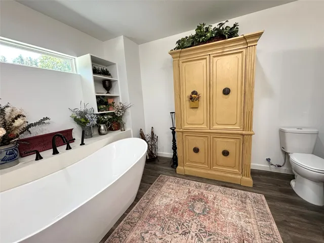 a spacious bathroom with a granite countertop sink and a mirror