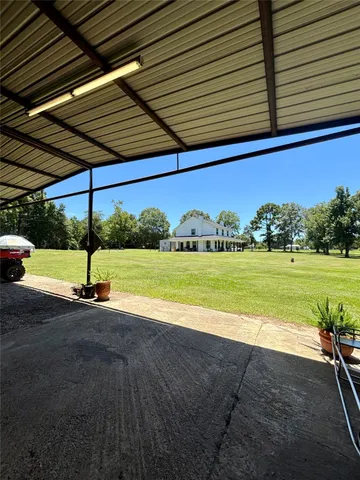 a view of a swimming pool with a yard